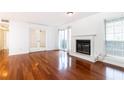 Inviting living room features a fireplace, hardwood floors, and access to outdoor space at 2901 Lenox Ne Way # 902, Atlanta, GA 30324