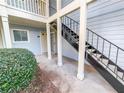 Exterior view showcasing staircase with black metal railings, white posts, and neatly trimmed bushes at 17 Matawan Se Cir, Smyrna, GA 30080