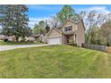 Charming two-story home with a two-car garage, well-manicured lawn, and inviting front porch at 4567 Hickory Forest Nw Dr, Acworth, GA 30102