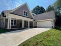 Charming one-story home featuring stone accents, a spacious driveway, and a convenient two-car garage at 117 Legends Way, Hiram, GA 30141