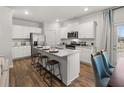 Modern kitchen with a center island, stainless steel appliances, and hardwood floors at 2462 Bayberry St, Acworth, GA 30101