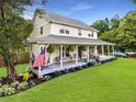 Inviting home featuring a generous wrap-around porch with porch swing and well manicured landscaping at 2832 Old Villa Rica Rd, Powder Springs, GA 30127