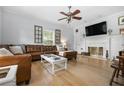 Cozy living room with a leather sofa, fireplace, and decorative windows that brings in natural light at 2832 Old Villa Rica Rd, Powder Springs, GA 30127