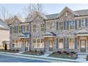 Attractive townhome exteriors with brick facade, gray shutters, and landscaped front yards at 475 Collins Industrial Way, Lawrenceville, GA 30046