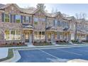 Modern brick townhomes with neat landscaping and convenient parking spaces at 475 Collins Industrial Way, Lawrenceville, GA 30046