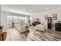 Spacious living room with a large sectional sofa, modern furnishings, and wood-look flooring at 625 Aunt Lucy Sw Ln # 34/19, Smyrna, GA 30082