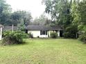 Single-story home with a well-maintained lawn and surrounded by mature trees at 2535 Glenwood Se Ave, Atlanta, GA 30317