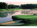 Picturesque view of golf course showcasing lush green grass and serene pond views at 520 Waterside Ct, Canton, GA 30114