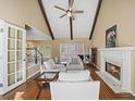 Bright living room boasts high ceilings, exposed beams, fireplace and abundant natural light at 520 Waterside Ct, Canton, GA 30114