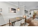 Bright dining room features stylish decor, a modern light fixture, and built-in shelving at 100 Brickworks Ne Cir # 104, Atlanta, GA 30307