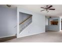 Open-concept living room with staircase, ceiling fan, and view into the kitchen at 3610 Ginnis Rd # 4, Atlanta, GA 30331