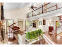 Bright living room with a piano, high ceilings, balcony, and hardwood floors at 4867 Township Trce, Marietta, GA 30066