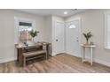 Bright dining area showcasing wood-look flooring, a farmhouse table, and modern trim at 488 Park Valley Nw Dr, Atlanta, GA 30318