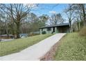 Quaint single-level home on a grassy lot with a private driveway and attached carport at 488 Park Valley Nw Dr, Atlanta, GA 30318