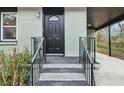 Inviting front entrance with a black door, decorative railing, and painted steps at 488 Park Valley Nw Dr, Atlanta, GA 30318