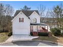 Inviting two-story home with covered porch and integrated garage offering scenic waterfront living at 730 Reeves Lake Sw Dr, Marietta, GA 30064