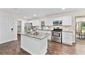 Bright kitchen features stainless steel appliances, white cabinetry and granite countertops at 3263 Dodson Dr, Atlanta, GA 30344