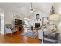 Spacious living room filled with natural light, hardwood floors, and a beautiful fireplace at 7295 Hickory Bluff Dr, Cumming, GA 30040