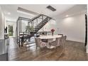 Elegant dining area with modern chandelier, table, and sophisticated seating adjacent to stairs at 1145 Kirkwood Se Ave # 4, Atlanta, GA 30316