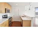 Bright kitchen with stainless steel appliances, natural wood cabinets, and quartz countertops at 361 17Th Nw St # 922, Atlanta, GA 30363