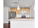 Open kitchen with stainless steel appliances, wood cabinets, and quartz countertops at 361 17Th Nw St # 922, Atlanta, GA 30363