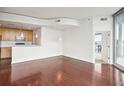 Spacious living room with hardwood floors, white walls, and an open layout connecting to the kitchen at 361 17Th Nw St # 922, Atlanta, GA 30363