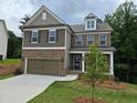 Charming two-story home with brick and siding, attached garage and beautiful landscaping at 508 Clayborne Way, Loganville, GA 30052