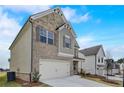 Charming two-story home with brick and stone accents, attached two-car garage, and well-maintained landscaping at 508 Clayborne Way, Loganville, GA 30052