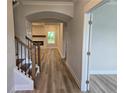 Welcoming foyer with hardwood floors, staircase, and views into the living room at 508 Clayborne Way, Loganville, GA 30052