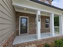 Inviting front porch with white columns and the house number displayed at 508 Clayborne Way, Loganville, GA 30052