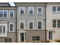 Stylish townhome featuring a brick base and gray siding, complemented by bright white trim and a welcoming entrance at 3165 Dogwood Dr # 106, Hapeville, GA 30354