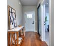Inviting hallway with wood floors, showcasing a decorative 'HOME' sign and a view into another room at 419 Mcinnes Se Cir, Marietta, GA 30060