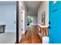 Inviting hallway with hardwood floors, bright blue front door, and decor at 419 Mcinnes Se Cir, Marietta, GA 30060