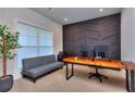 Modern office space with textured wall, large window, and gray futon at 419 Mcinnes Se Cir, Marietta, GA 30060