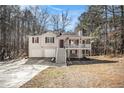 Charming home with a welcoming front porch, white siding and complemented by the surrounding trees at 40 Joolio Dr, Rockmart, GA 30153