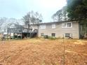 Rear exterior of home with brick facade and upper deck overlooking the backyard at 3750 Dial Mill Ne Rd, Conyers, GA 30013