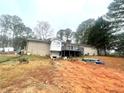 Backyard view of a brick home featuring a spacious wooden deck perfect for outdoor entertaining at 3750 Dial Mill Ne Rd, Conyers, GA 30013