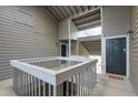 Open air condo entrance with stairs, railings, and the front door in a neutral palette at 128 Warm Springs Cir, Roswell, GA 30075