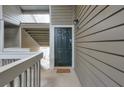 A welcoming condo entrance features a neutral door and a charming welcome mat on the porch at 128 Warm Springs Cir, Roswell, GA 30075