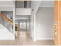 Open entryway showcasing beautiful hardwood floors, a staircase, and a view into the living room at 2030 Brook Meadow Dr, Alpharetta, GA 30005