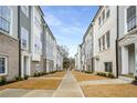 Exterior street view of multiple townhomes, featuring a sidewalk and manicured lawns at 3165 Dogwood Dr # 108, Hapeville, GA 30354