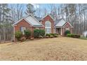 Inviting brick home with a well-kept lawn and mature landscaping at 51 Brookshire Ct, Dallas, GA 30157