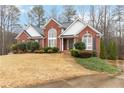 Attractive brick house with lush landscaping and a curved walkway leading to the entrance at 51 Brookshire Ct, Dallas, GA 30157