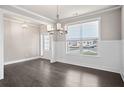 Bright dining room boasts dark hardwood floors, wainscoting, and ample natural light at 5995 Spring Way, Stonecrest, GA 30038