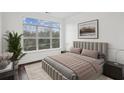 Comfortable bedroom with a large window offering scenic views, plush bedding, and contemporary decor at 840 United Se Ave # 411, Atlanta, GA 30312