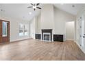 Bright living room features vaulted ceilings, a fireplace, and hardwood floors, exuding warmth and style at 602 Sandhill Hickory Level Rd, Carrollton, GA 30116