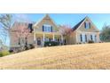 Desirable home boasts a cozy front porch and lush landscaping, ideal for outdoor enjoyment at 103 Old Avery Dr, Canton, GA 30115