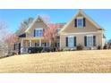 Attractive home with a covered porch and blooming trees, set on a spacious, grassy lot at 103 Old Avery Dr, Canton, GA 30115