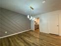Dining area featuring modern light fixture and view into the kitchen at 3060 Parc Lorraine, Lithonia, GA 30038