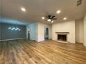 Spacious living room with wood flooring, fireplace, and stylish light fixture at 3060 Parc Lorraine, Lithonia, GA 30038